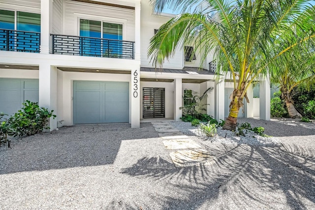 exterior space with a balcony and a garage