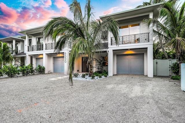 view of front of house featuring a balcony and a garage