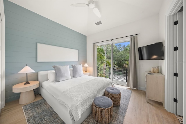 bedroom with ceiling fan, light hardwood / wood-style floors, and access to exterior