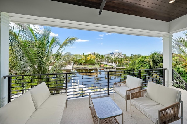 balcony with a water view and an outdoor hangout area