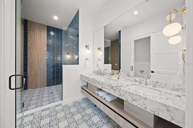 bathroom with vanity, tile patterned floors, and a shower with door