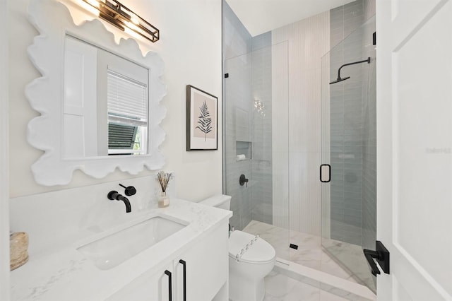 bathroom with vanity, toilet, and a shower with shower door