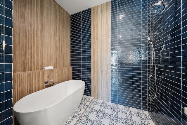 bathroom featuring independent shower and bath and tile walls