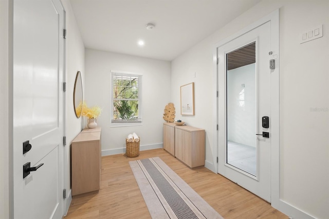 mudroom with light hardwood / wood-style floors