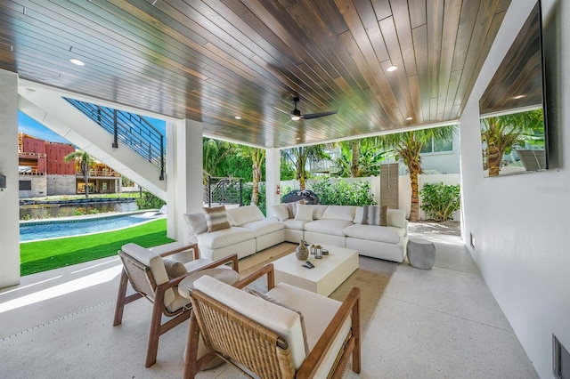 view of patio / terrace featuring an outdoor hangout area, a water view, and ceiling fan