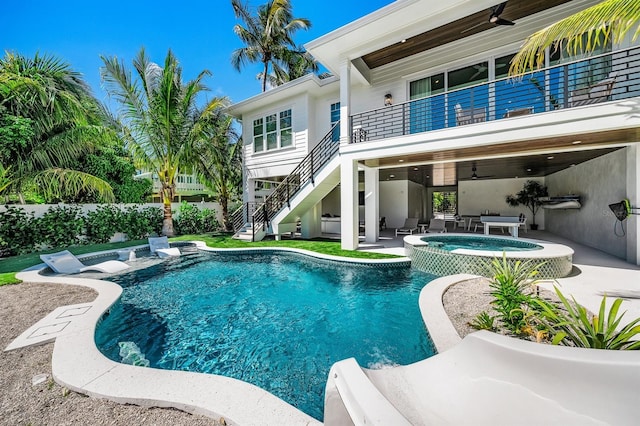 view of swimming pool featuring ceiling fan, a patio area, and an in ground hot tub