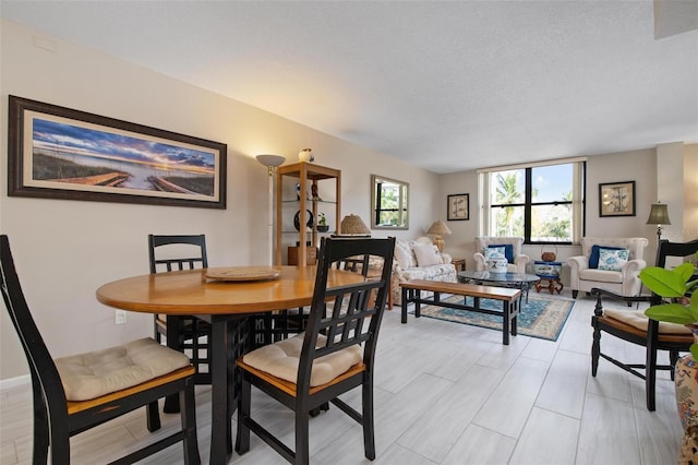 dining space featuring a textured ceiling