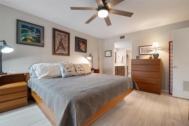 bedroom featuring connected bathroom, ceiling fan, and light hardwood / wood-style floors