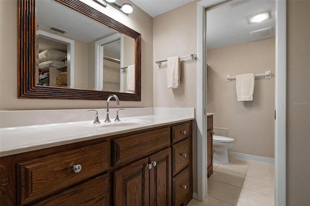 bathroom with tile patterned floors, vanity, and toilet