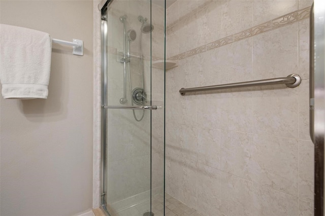 bathroom featuring a shower with shower door