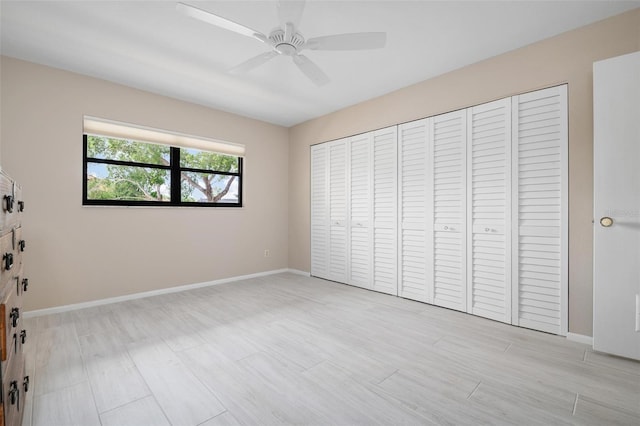 unfurnished bedroom featuring ceiling fan, a closet, and light hardwood / wood-style flooring