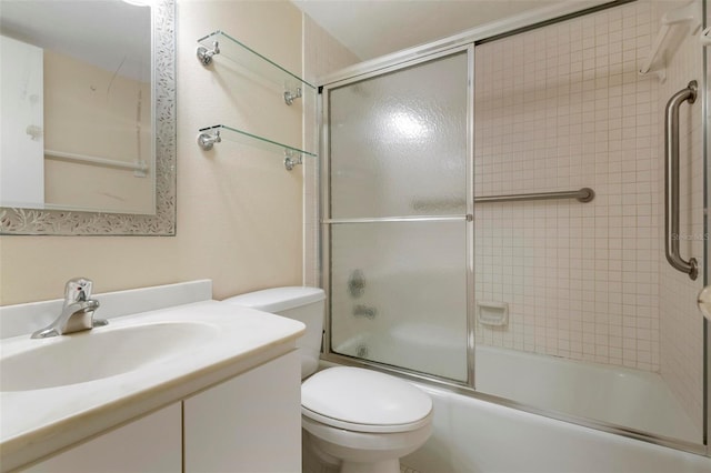 full bathroom featuring combined bath / shower with glass door, vanity, and toilet