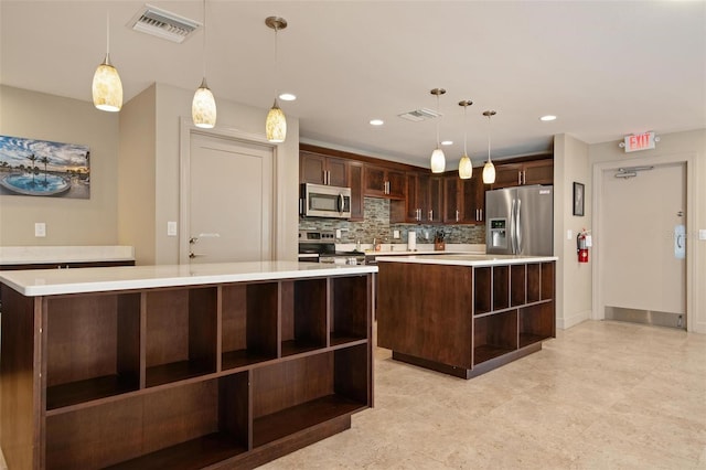 kitchen with dark brown cabinetry, a large island, stainless steel appliances, decorative light fixtures, and decorative backsplash