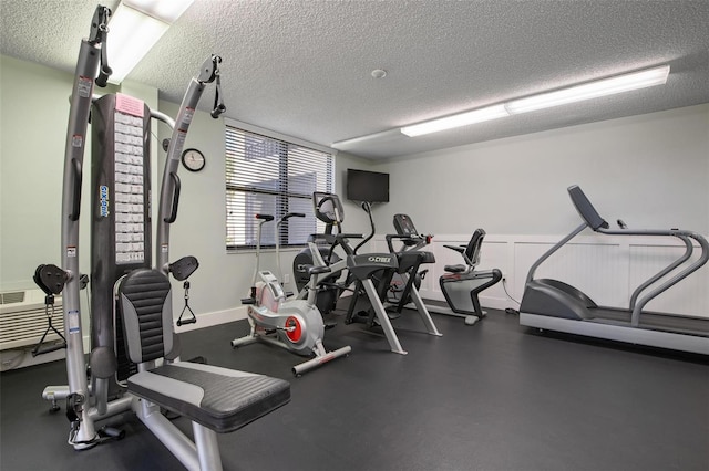 exercise room featuring a textured ceiling