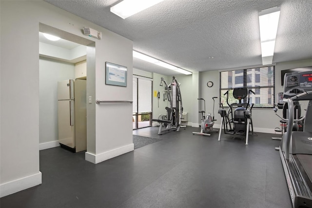 exercise room with a textured ceiling