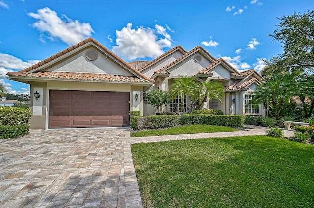 mediterranean / spanish-style home with a garage and a front yard