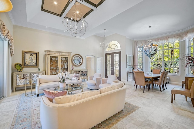 living room with french doors, a chandelier, a high ceiling, and ornamental molding