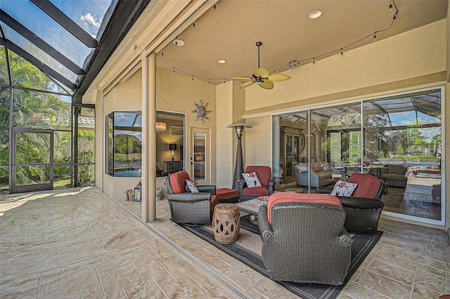 view of patio / terrace featuring ceiling fan, a lanai, and an outdoor hangout area