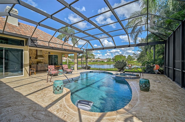 view of pool with an outdoor kitchen, a water view, a lanai, an in ground hot tub, and a patio