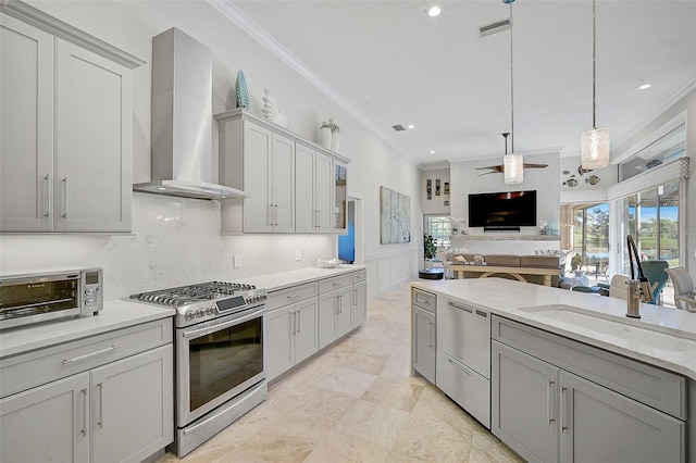 kitchen with stainless steel appliances, gray cabinets, and wall chimney range hood