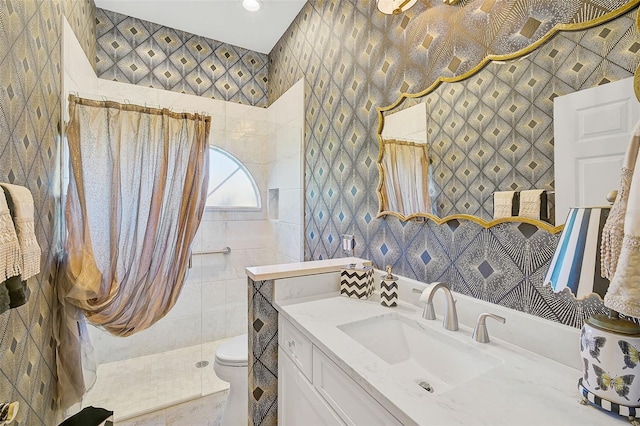 bathroom featuring a shower, vanity, and toilet