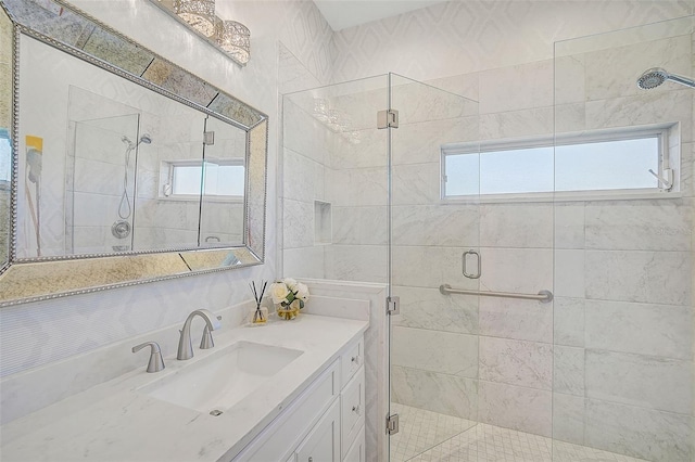 bathroom featuring a wealth of natural light, vanity, and an enclosed shower