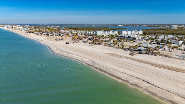 birds eye view of property featuring a beach view and a water view