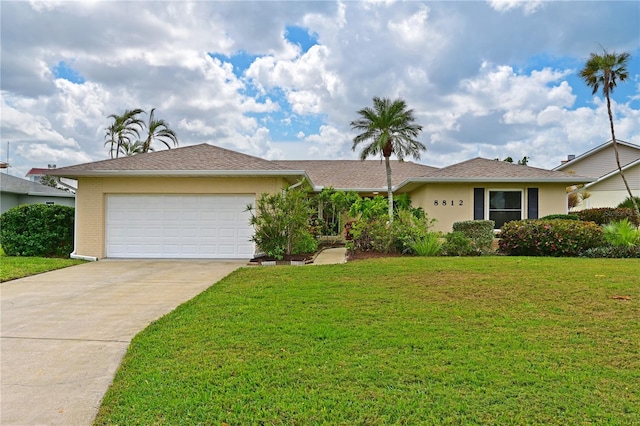 ranch-style home with a garage and a front lawn