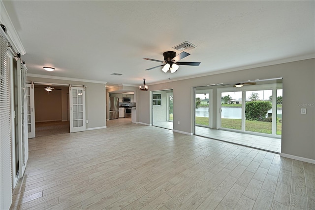 unfurnished living room featuring light hardwood / wood-style floors, a water view, and crown molding