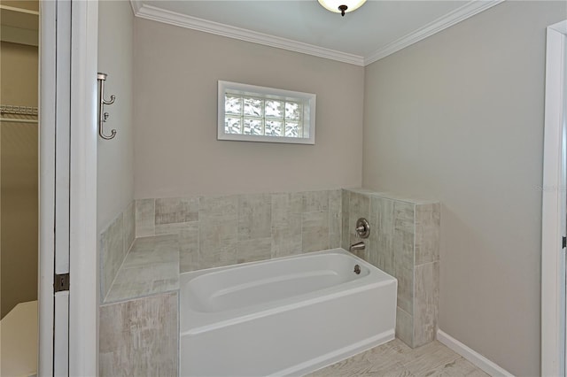 bathroom with a bath and crown molding