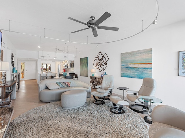 living room with hardwood / wood-style floors and ceiling fan