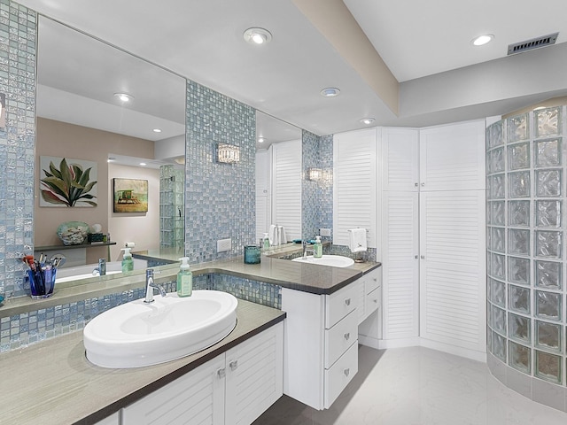 bathroom featuring vanity, a shower, and backsplash