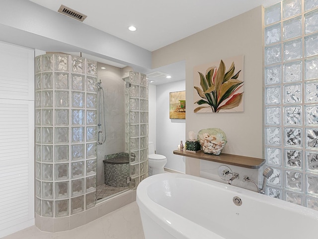 bathroom featuring shower with separate bathtub and toilet