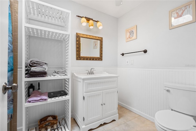 bathroom with vanity, toilet, and tile patterned flooring