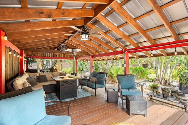 wooden terrace with a gazebo, an outdoor living space with a fire pit, and ceiling fan