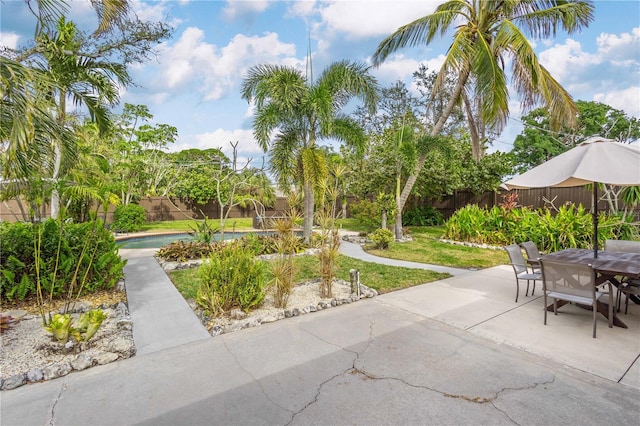 view of home's community with a pool and a patio area