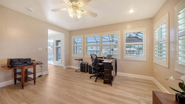 office area with ceiling fan and light hardwood / wood-style flooring