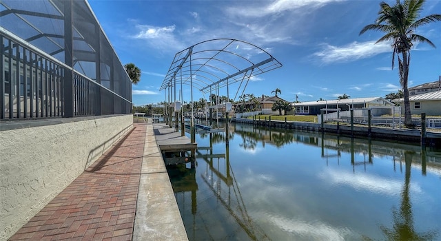 view of dock with a water view and glass enclosure