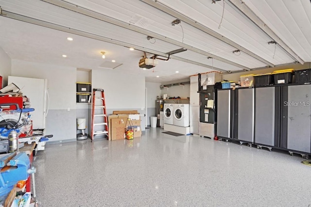 garage with separate washer and dryer, a garage door opener, and white refrigerator