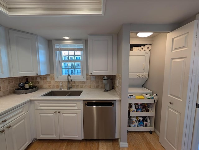 kitchen with white cabinets, stainless steel dishwasher, and sink