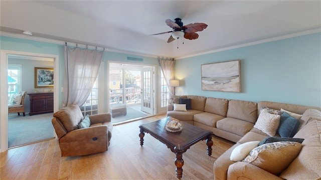 living room featuring ceiling fan, light hardwood / wood-style flooring, and ornamental molding