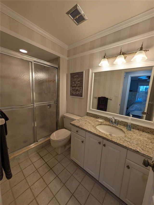 bathroom with tile patterned floors, toilet, vanity, a shower with shower door, and ornamental molding