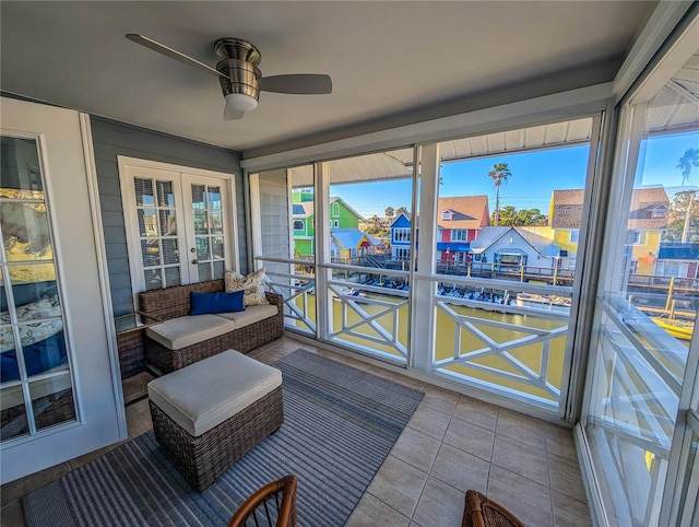 sunroom / solarium featuring ceiling fan and french doors