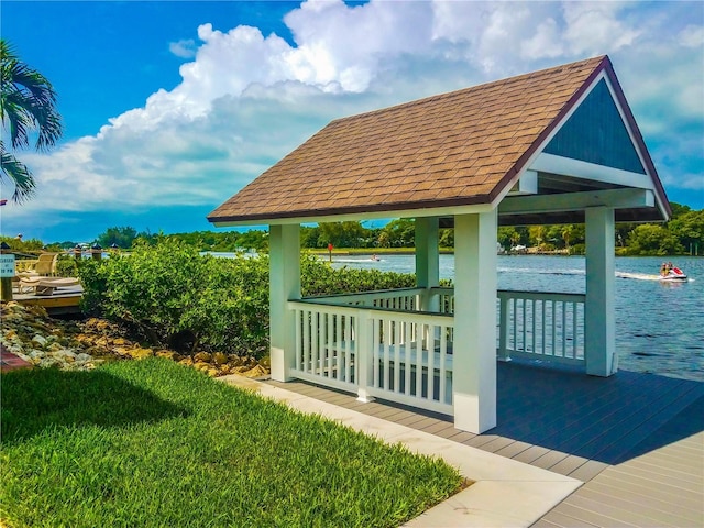 view of community featuring a gazebo, a water view, and a lawn