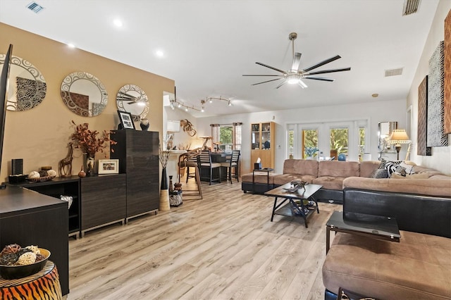 living room with french doors, light hardwood / wood-style floors, and ceiling fan