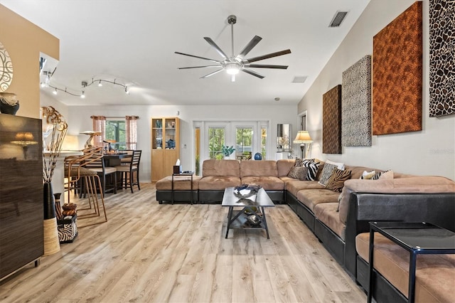 living room with ceiling fan, light hardwood / wood-style flooring, and french doors