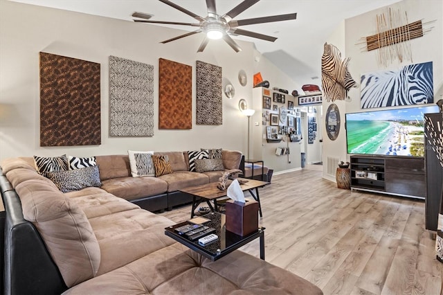 living room featuring ceiling fan, lofted ceiling, and light hardwood / wood-style flooring