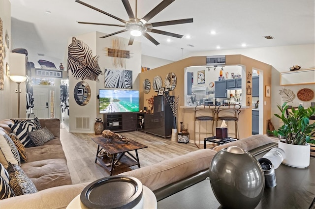 living room featuring ceiling fan and light hardwood / wood-style floors