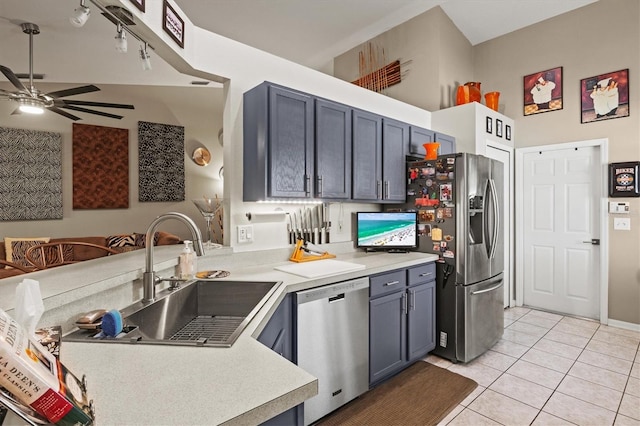 kitchen with ceiling fan, sink, stainless steel appliances, kitchen peninsula, and light tile patterned floors