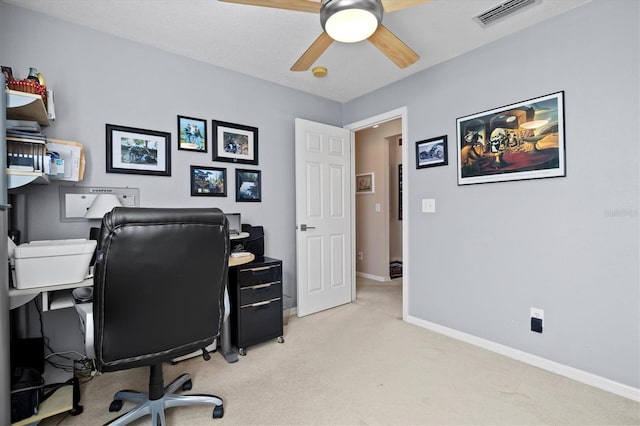 office space featuring ceiling fan and light colored carpet